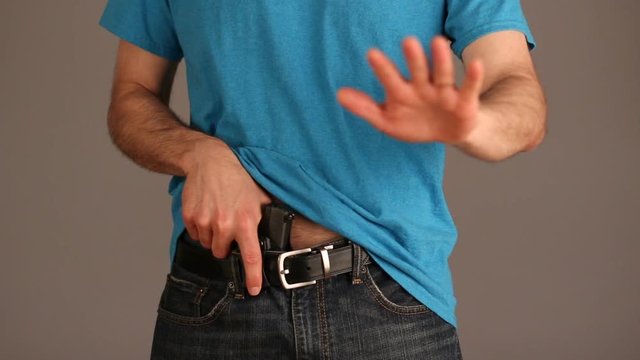 Man demonstrating concealed carry gun draw