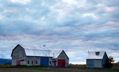 Fototapeta na wymiar Old barn under a beautiful sky before sunset