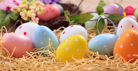 Easter eggs on straw background