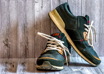 Men's dirty sneakers are blue in the hall near the wall