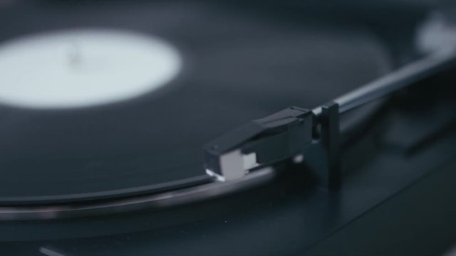 EXTREME CU Needle goes off vinyl record on a modern turntable. 4K UHD RAW edited footage