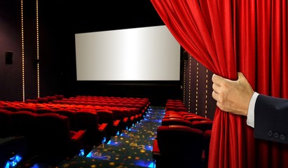 Cinema seats and blank screen with hand opening red curtain