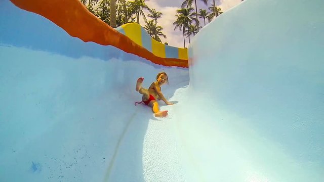 Girl on the water slide in aqua park