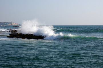 The sea wave is broken about stones