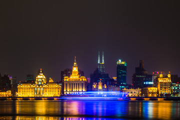 Fototapeta premium Night view of River Boats on the Huangpu River and as Background the Skyline of the Northern Part of Puxi 