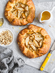 Caramelized pear rustic pie on light background, top view.
