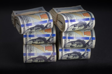 stacked $100 dollar bills rolls prop