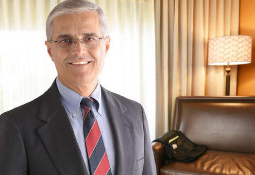 Mature Businessman in Hotel Room