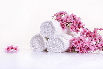 Fototapeta na wymiar Tropical Spa with blooming branch with towel 