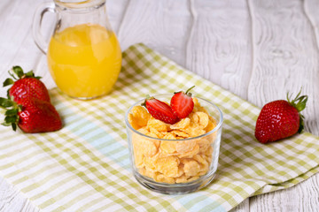 healthy breakfast with cereal flakes, strawberry, orange juice
