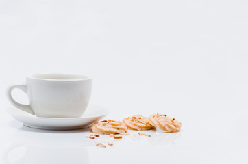 Empty coffee cup waiting to be filled. And cookies on white background