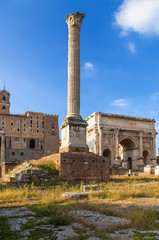 Rome, Italy. The Roman forum, from left to right: the column of Phocas (608) and the arch of Septimius Severus (205 AD)