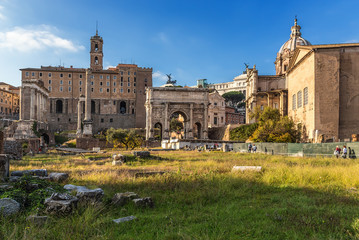 Fototapeta premium Rome, Italy. The ruins of the Roman Forum: the temple of Saturn, the temple of Vespasian, Tabularia, the basilica Julia, the arch of Septimius Severus, the column of Phocas, Curia Julia