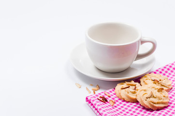 Empty coffee cup waiting to be filled. And cookies on white background
