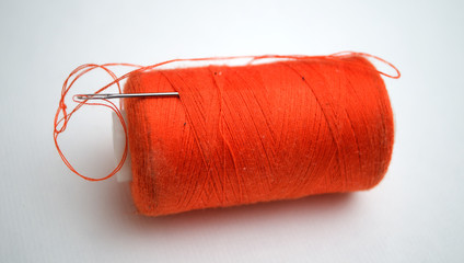 The orange thread with a needle