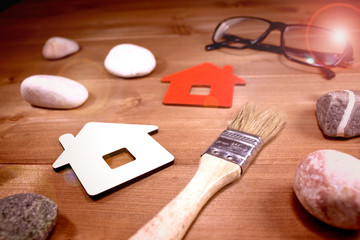 Fototapeta na wymiar Sign Home, brush, glasses and stones - concept of building or repairing houses