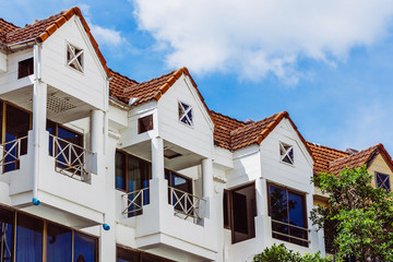 The terraces of a house. The roof and the small terraces on a white wooden house from below.