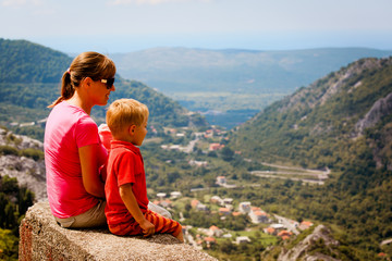 mother with kids trave in mountains