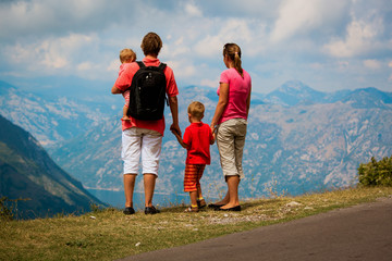 family with kids travel hiking in mountains