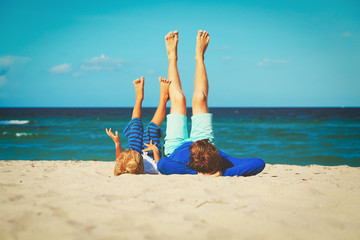 Fototapeta na wymiar father and little son play on beach