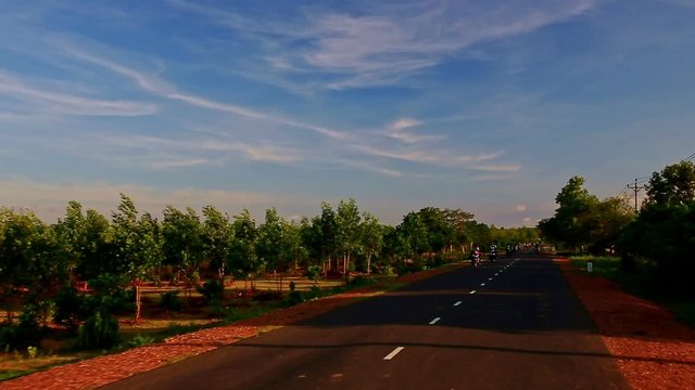 Motion along Shady Sunny Road Scooter Traffic by Rural Landscape