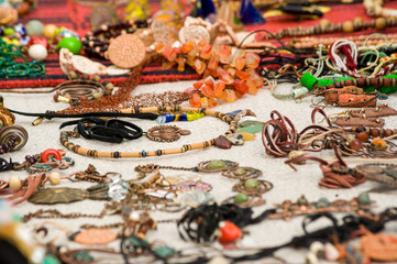 Many handmade jewelery are on the counter