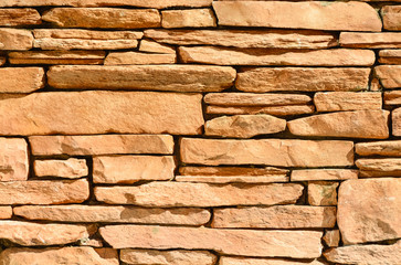 Sand colored stone setting. Stone wall texture.