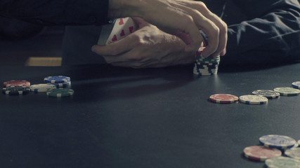 Poker game. Man's hands dealing cards and chips