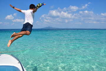 man jumps into the sea on his holiday