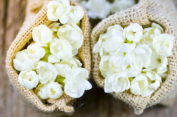 Blurry, Jasmine flower in burlap bag on old wood background,select focus