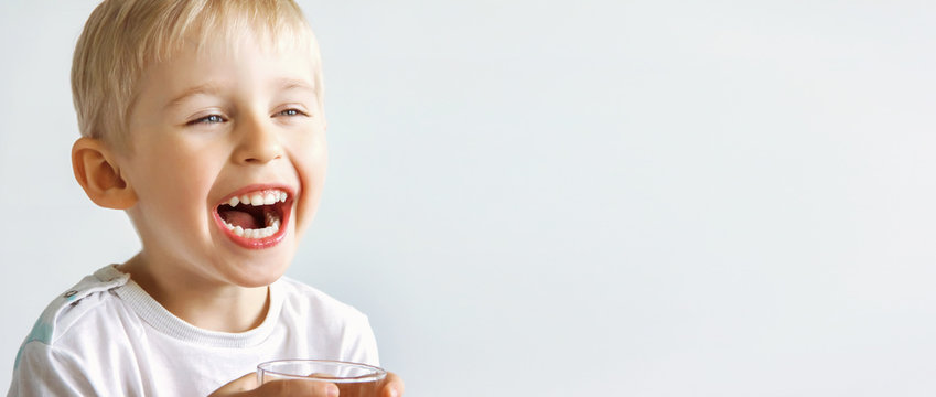 cheerful laughing boy showing healthy teeth, the child expresses emotions