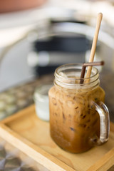 Thai Iced coffee with milk in a glass mason jar.