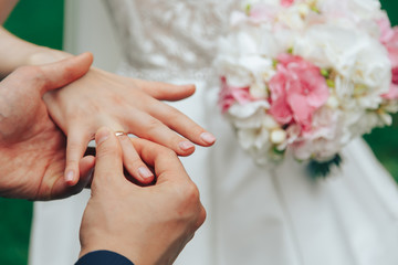 Obraz na płótnie Canvas .The groom puts on an engagement ring