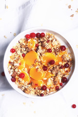 Breakfast granola with cranberries banana and mango mousse