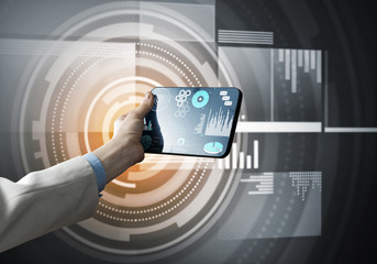 Media technology concept presented by businessman holding tablet with graphs and diagrams