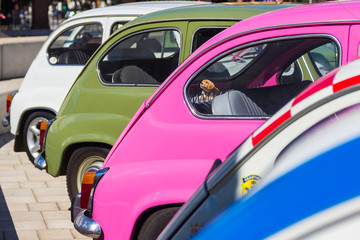 A Seat 600 row car in an International outdoor exhibition of classic vintage cars.
