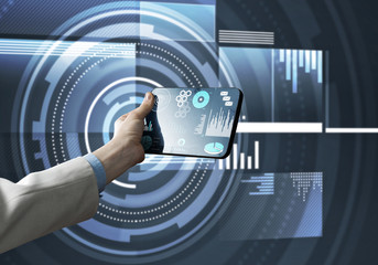Media technology concept presented by businessman holding tablet with graphs and diagrams