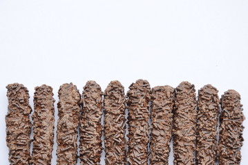 chocolate coated biscuit sticks on white background