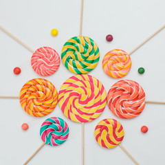 Pattern sweet lollipops, candy on white background, top view flat lay. Square