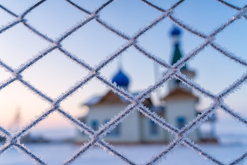 Frozen fence of church covered by snow and ice in winter, Baikal lake, Russia