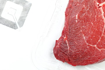The fresh cow beef in food grade transparent packaging and rfid tag represent the food raw material and meat concept related idea.