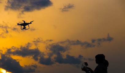 In the setting sun, drone and girls' silhouette