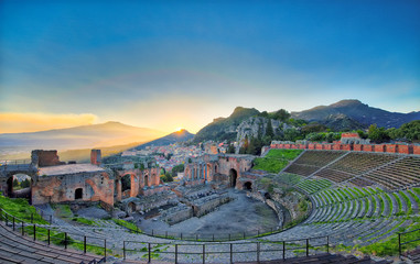 View of the ancient greek theater of Taormina with Etna volcano