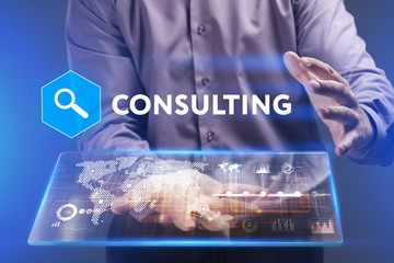 Fototapeta premium Business, Technology, Internet and network concept. Young businessman working on a virtual screen of the future and sees the inscription: Consulting