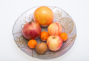 mix fresh fruits on plate isolated on white