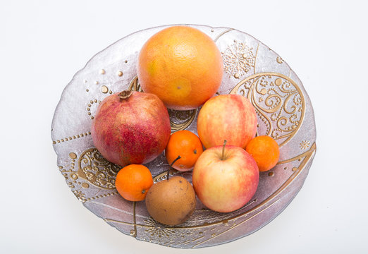 mix fresh fruits on plate isolated on white