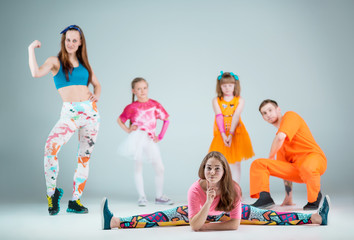 Group of man, woman and teens dancing hip hop choreography