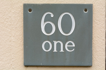 House number 61 sign on wall