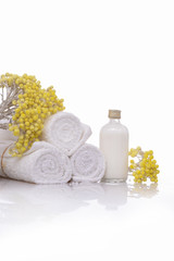 Obraz na płótnie Canvas Products for spa towel, spa oil, branch yellow flower