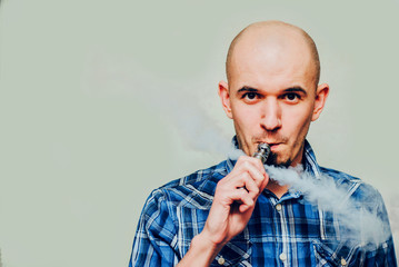 Close up of a man vaping.